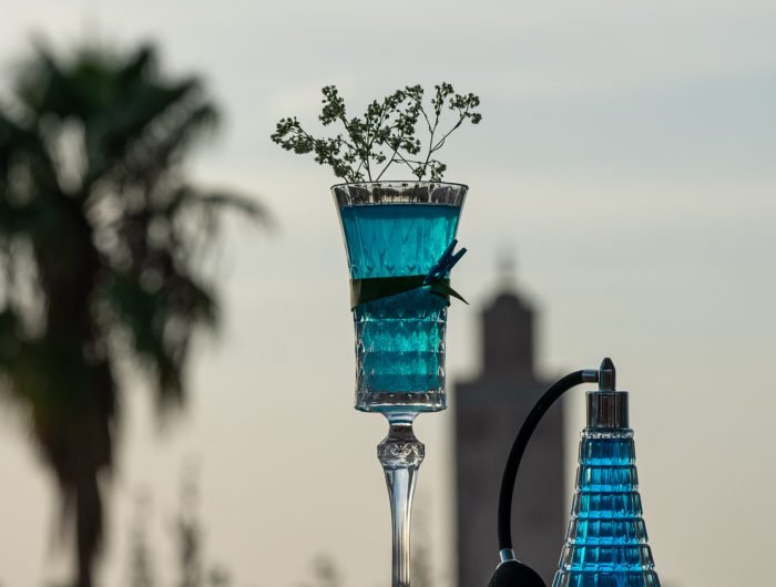 Rooftop bar Marrakech with panoramic views of Koutoubia Mosque and Atlas Mountains at sunset — Dardar Rooftop