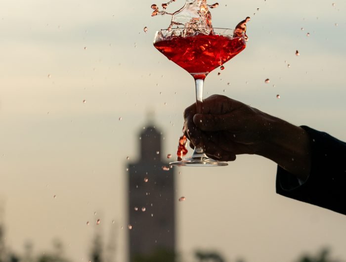 Rooftop restaurant in Marrakech Medina with panoramic views of Koutoubia Mosque and Atlas Mountains at sunset
